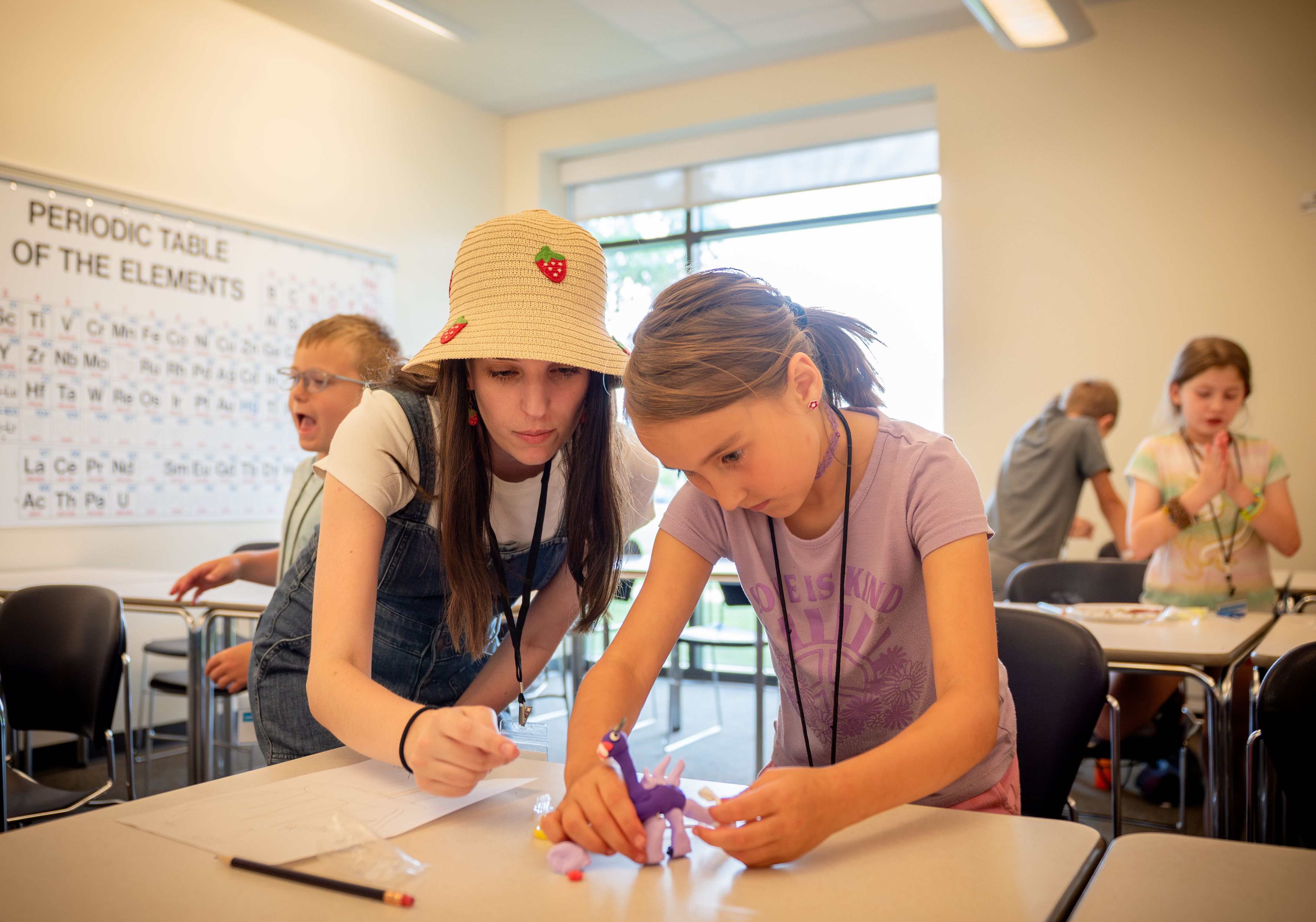 Student and presenter engaged in hands on learning.